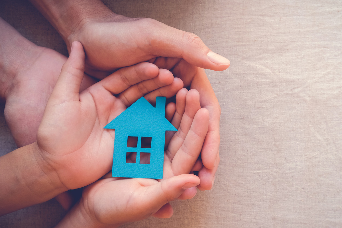 Hands holding a house